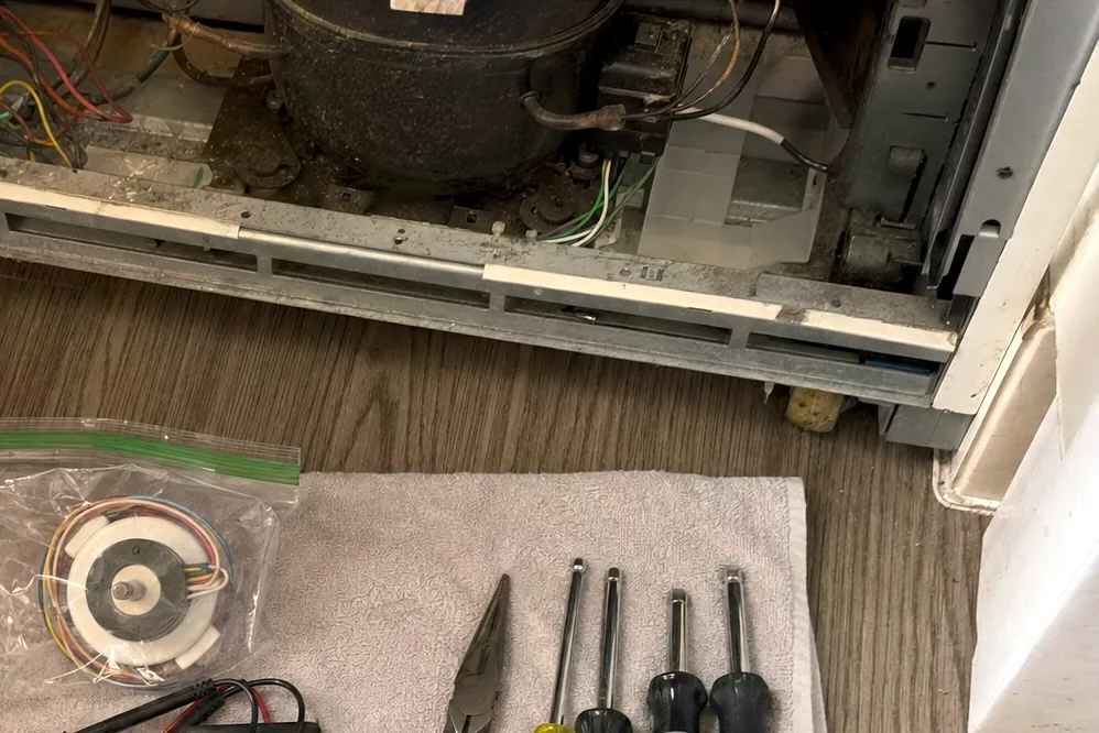 A close view of a multimeter and its red and black test leads resting on a folded work towel